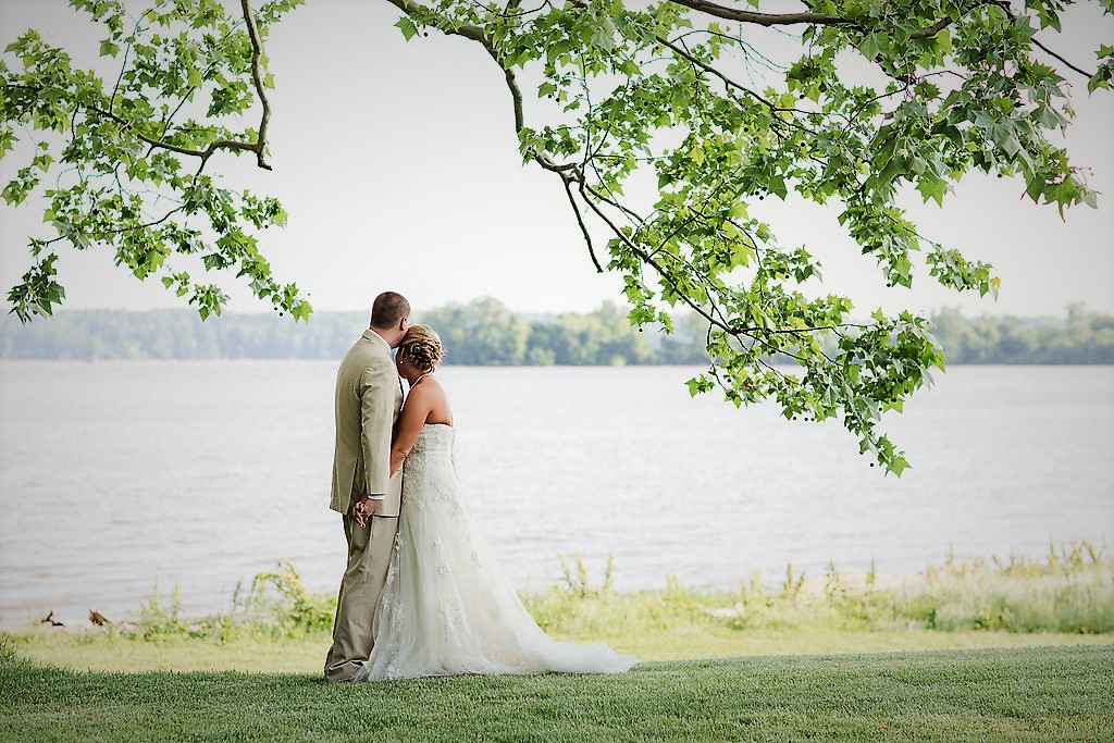 Weding couple looking over a lake after ceremony